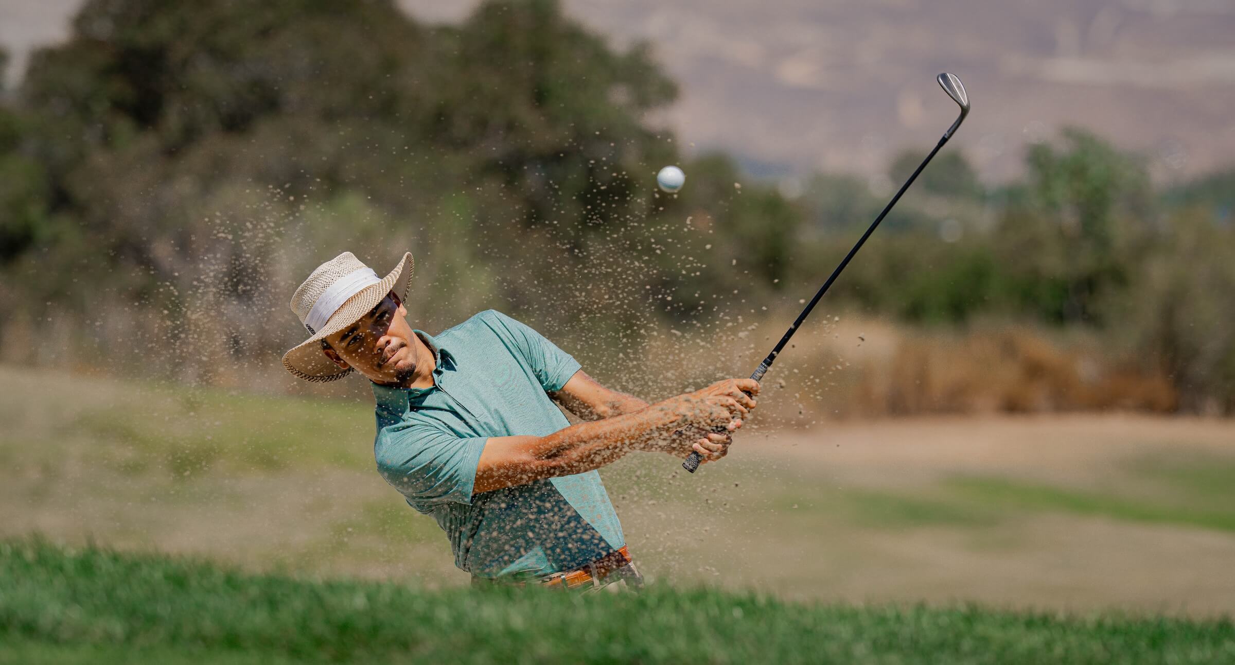 Golfer in Kingsmen Polo shot from the front during a swing