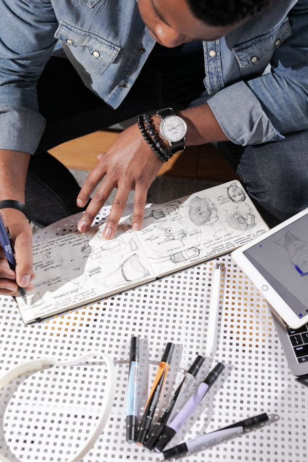 Kingsmen Founder Donald doing sketches of new products