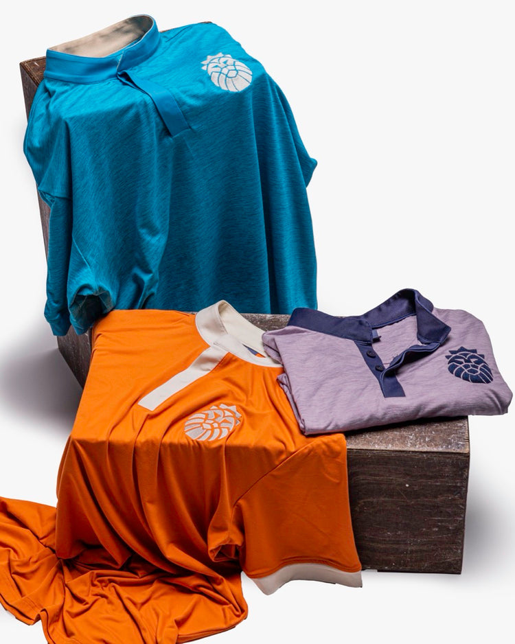 Three beautiful Kingsmen golf polos in a well lit studio shoot